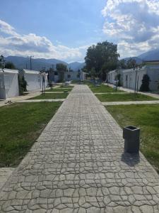 a cobblestone street with a trash can on it at Krikonis Apartments Leptokarya in Leptokarya