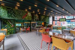 a restaurant with tables and chairs and a green wall at Park Inn by Radisson Istanbul Asia Kavacik in Istanbul