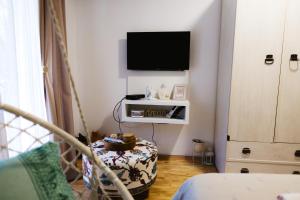 a living room with a tv on a wall at Apartmani Jovčić in Leskovac