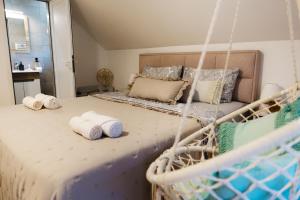 a bedroom with a bed with towels on it at Apartmani Jovčić in Leskovac