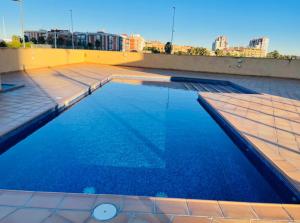 a swimming pool on the roof of a building at Loft en Valencia in Burjassot