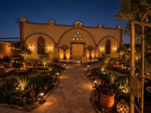 a courtyard of a building with lights and torches at Luxor Mountain View in Luxor