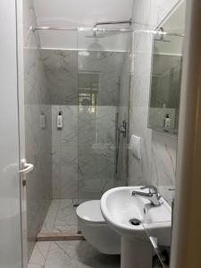 a bathroom with a shower and a toilet and a sink at Petriti theth in Theth +120 photos