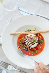 a white plate with food on a table at Domaine des Dryades - Hôtel & Spa in Pouligny-Notre-Dame