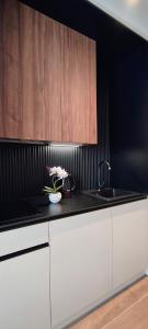 a kitchen with a sink and a vase of flowers on a counter at Sky Panorama in Soko Banja