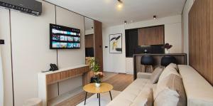 a living room with a couch and a flat screen tv at Sky Panorama in Soko Banja