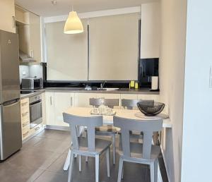a kitchen with a table and chairs in a room at Zen Central Luxury Apartment in Heraklio