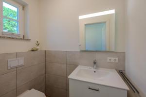 a bathroom with a sink and a mirror at Traumgarten Traumzeit in Prerow +29 photos