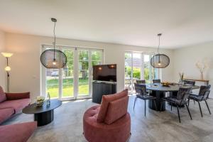 a living room with a couch and a table at Traumgarten Traumzeit in Prerow