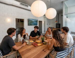 a group of people sitting around a wooden table at Password to Madrid Casa de Campo in Madrid
