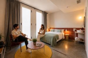 a man and a woman sitting in a hotel room at Password to Madrid Casa de Campo in Madrid
