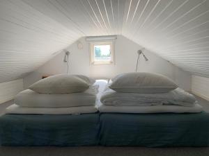two pillows on top of a bed in a attic at Kullahalvön nära Jonstorps hamn in Jonstorp