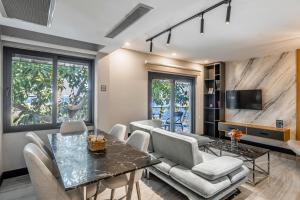 a living room with a table and chairs at Çimentepe Residence Deluxe 6 - Residence Apartment in Yalikavak in Bodrum City