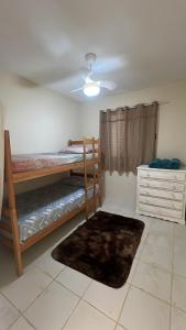 a bedroom with two bunk beds and a ceiling at Apartamento 2 quartos ,Mobiliado em Sumare SP in Sumaré