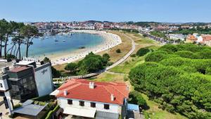 a view of a beach with boats in the water at GALIHOST - Casa Chouba, frente a la playa in Sanxenxo