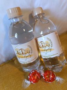 two bottles of water and red candies on a table at Serendipity Guest House in Richards Bay +57 photos