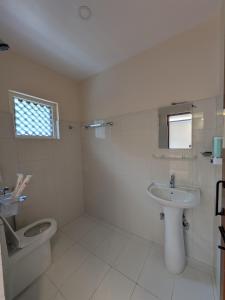 a bathroom with a toilet and a sink at Sukute River Hub Beach Resort in Dolālghāt