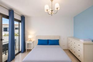 a bedroom with a large bed and a chandelier at GuestReady - Tarantos Sea View and Pool in Playa del Ingles +42 photos