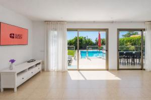 a large living room with a view of a pool at GuestReady - Tarantos Sea View and Pool in Playa del Ingles