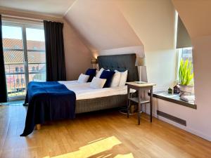 a bedroom with a large bed and a window at Maritim Hotell & Krog in Simrishamn