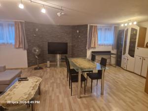 a living room with a table and chairs and a television at Justyna-Sebastian FE-WO in Paderborn