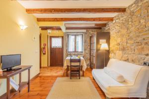 a living room with a white couch and a table at Zelaikoa Behekoa - baskeyrentals in Zestoa