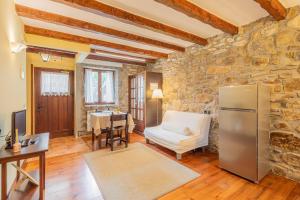 a living room with a refrigerator and a table at Zelaikoa Behekoa - baskeyrentals in Zestoa
