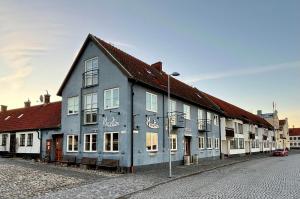 a blue and white building on a street at Maritim Hotell & Krog in Simrishamn
