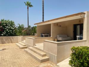 a house with stairs and a couch in it at Finca Sol y Mar Es Trenc in Campos