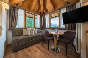 a living room with a couch and a table at Hotel Crozzon in Madonna di Campiglio