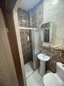 a bathroom with a sink and a toilet and a mirror at Hotel Megaron in Istanbul