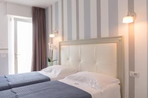Ένα ή περισσότερα κρεβάτια σε δωμάτιο στο Gruppo Luxe Domus Vigevano