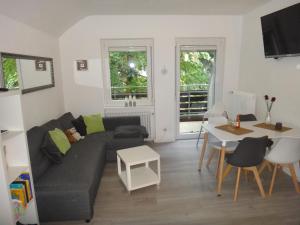 a living room with a couch and a table at Fewo Andresen Hahnenklee in Hahnenklee-Bockswiese