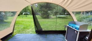a tent with a tv in the middle of a field at De Zanglijster in Erica