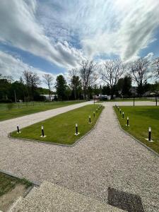 a park with a row of lights in the grass at Noclegi Antoniewo in Morąg