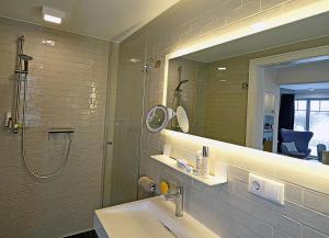 a bathroom with a sink and a shower and a mirror at Auszeit am Meer in Dranske +13 photos
