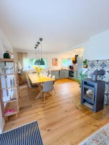 a living room with a table and a wood stove at Landhaus Holly in Frielendorf