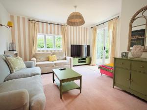 a living room with a couch and a table at The Cottage at Cobbolds Mill in Monks Eleigh