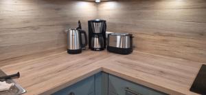 a counter with two coffeemakers sitting on top of it at White Coast Villa in Grömitz
