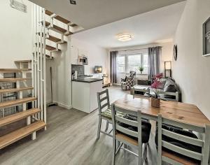 a kitchen and living room with a table and chairs at Bugoase in Dranske