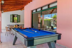 a pool table in a living room with a pool table at Villa Poppy by Villa Plus in Polis Chrysochous