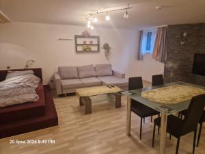 a living room with a couch and a table at Justyna-Sebastian FE-WO in Paderborn +4 photos