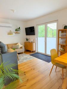 a living room with a table and a couch at Landhaus Holly in Frielendorf