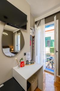 a room with a table and a mirror and a bed at Swan Paradise Nafplio in Nafplio +103 photos