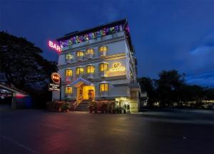 a lit up building with a sign on top of it at Chandni Park in Ernakulam