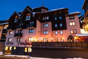 a hotel in the snow at night at Hotel l'Aigle in Valmeinier