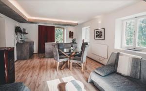 a living room with a table and chairs at STILFSER HÜTTL Ein ganzes Ferienhaus für euch in SÜDTIROL in Alleinlage mit Ortlerblick euer Refugium mit privatem Gartenbereich für gemeinsame Zeit zu zweit mit Familie und Freunden und Hund im Nationalpark Stilfserjoch WINTER Skigebiet in d Nähe SULDEN in Stelvio