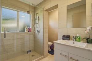 a bathroom with a glass shower and a sink at Springfield bliss with Lake view in Rotorua +14 photos