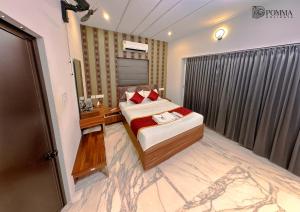 a small bedroom with a bed and a window at Pomma Holidays and Resorts in Muthanga