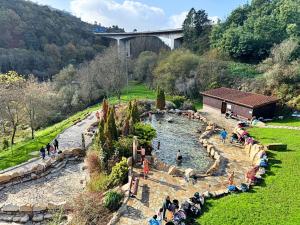 a group of people standing around a water fountain at O recuncho - Alojamiento tranquilo cerca de Ribeira Sacra y Ourense in Maceda